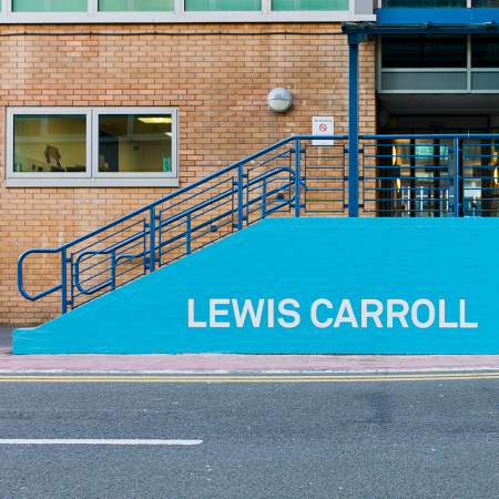 University of Surrey Wayfinding Lewis Carroll installed on brick wall