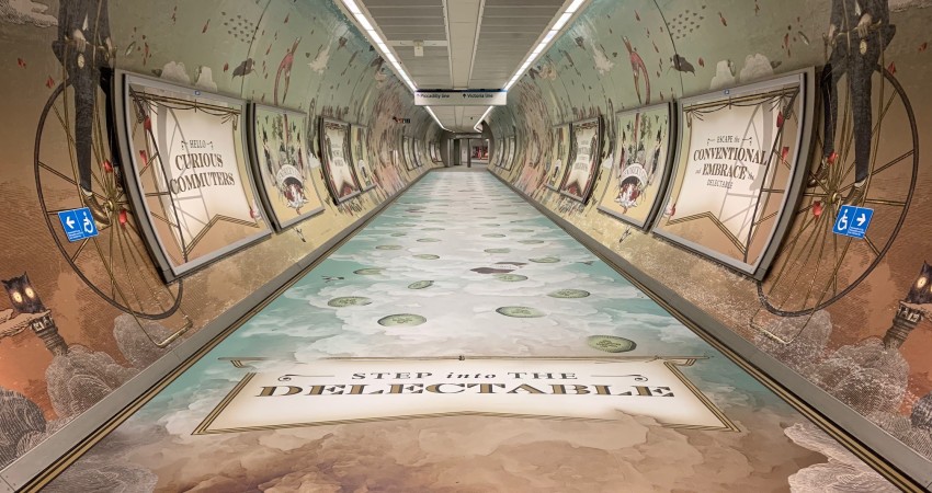 St Pancras tube station tunnel with Hendricks scented print graphics